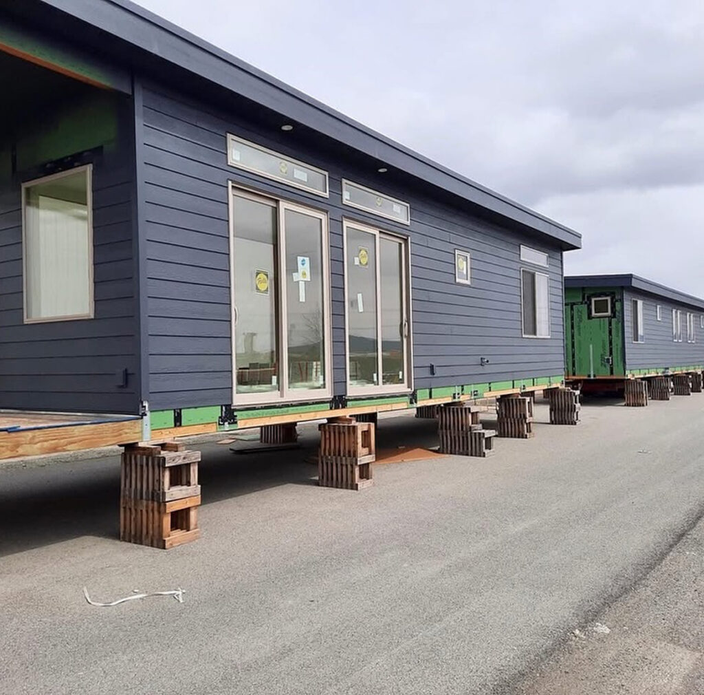 Prefabricated home sections staged on support blocks ready for delivery and installation
