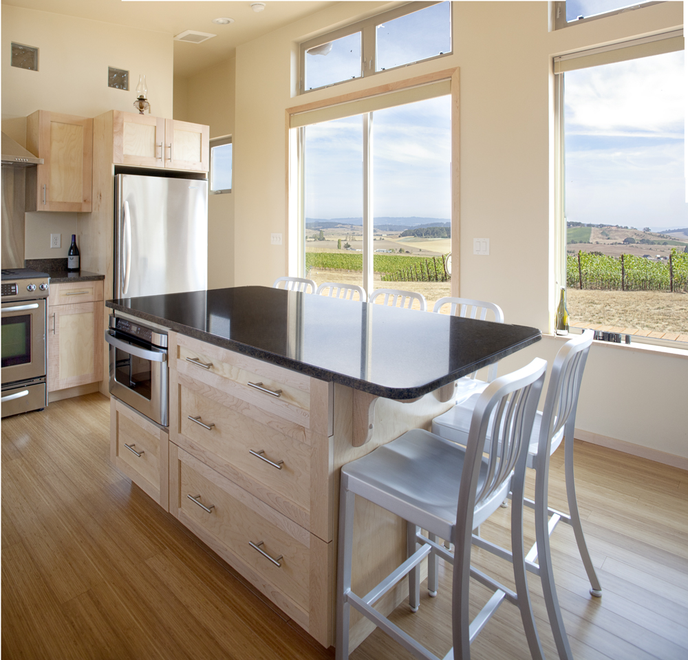 Spacious modern kitchen with island and dining area in a prefab home.