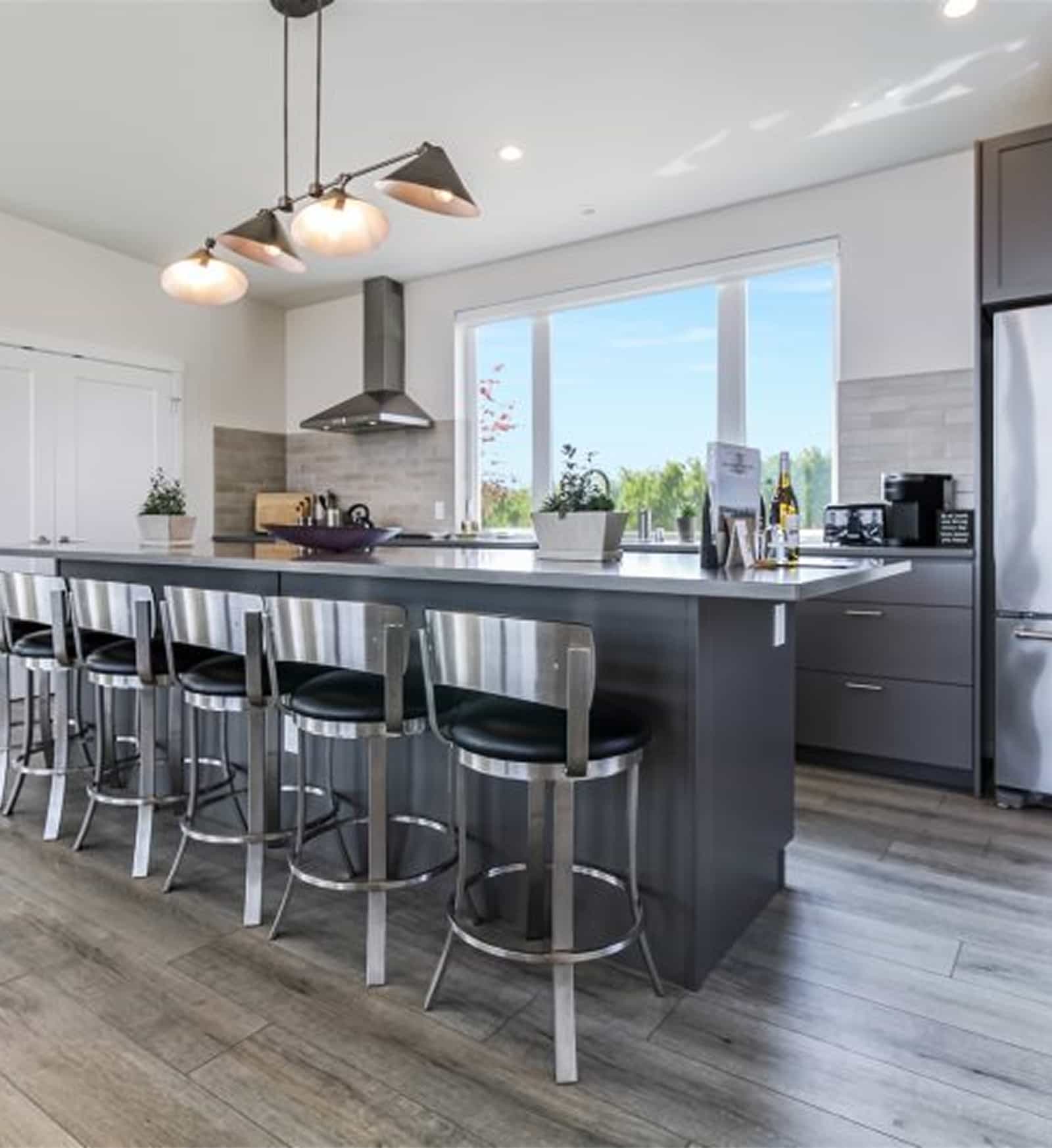 Bryn Mawr prefab home kitchen with modern finishes stainless steel appliances and a large island with bar seating