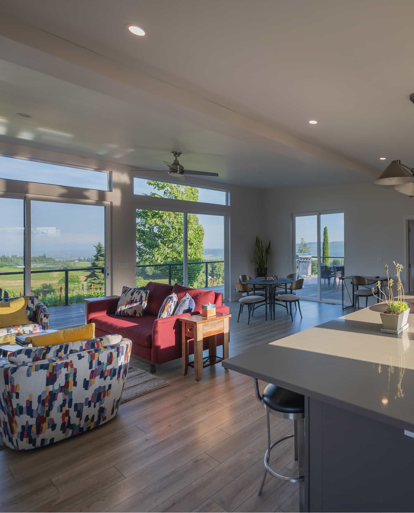 Bryn Mawr prefab home interior with colorful furniture large windows and scenic vineyard views