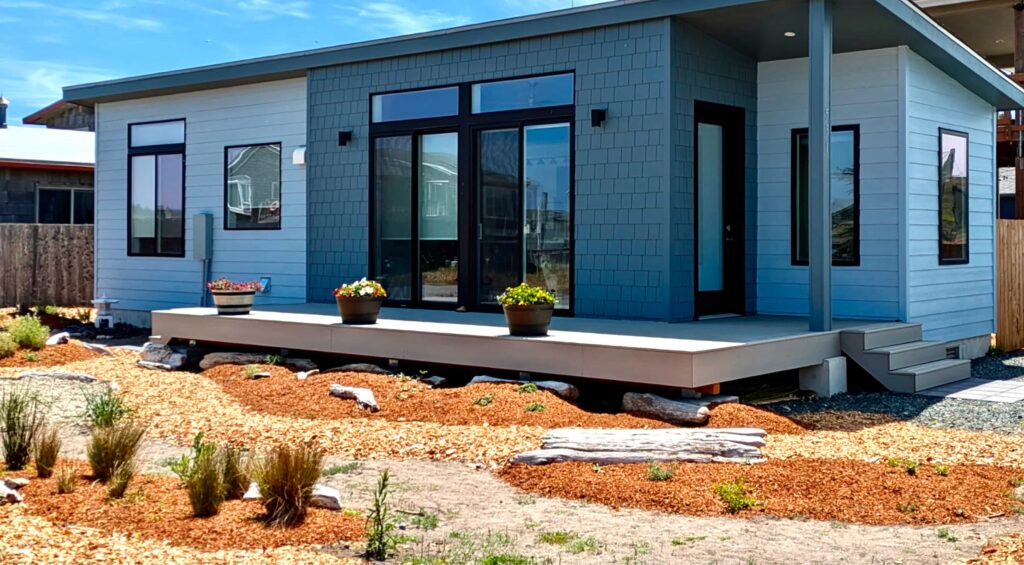 Cauthorn Beach Cottage prefab home with modern design front porch and coastal landscaping