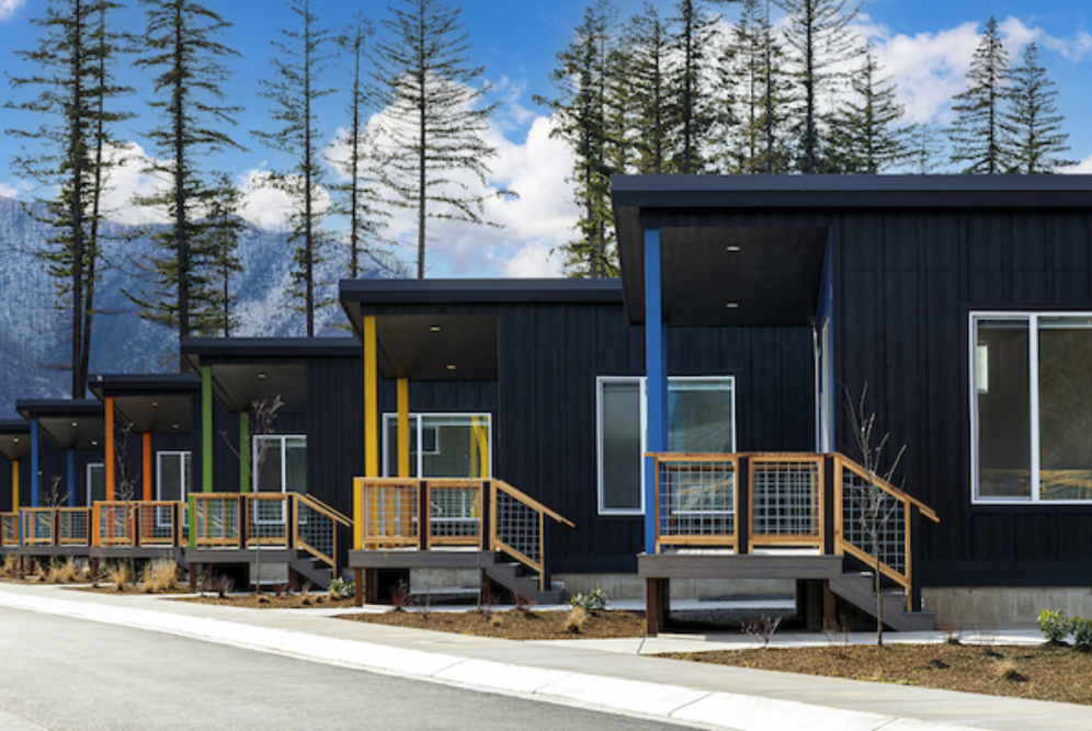 Row of compact modern homes featuring colorful front columns and clean lines